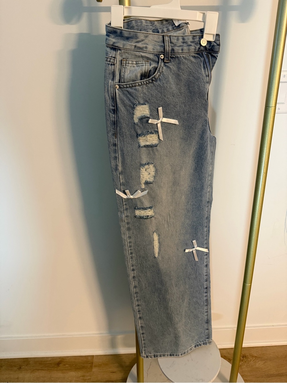 Blue jeans with ribbon bows